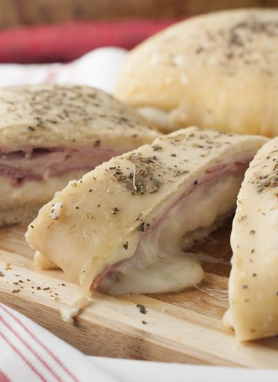 Ham and Cheese Stromboli appetizer recipe is begging to be served at your next game day party or holiday gathering! Oozing with cheese, this snack could easily pass as a main course for dinner!