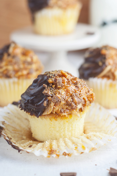The ultimate soft and fluffy Vanilla Butterfinger Cupcakes are loaded with flavor and the perfect birthday dessert recipe for the candy and peanut butter lover in your life!