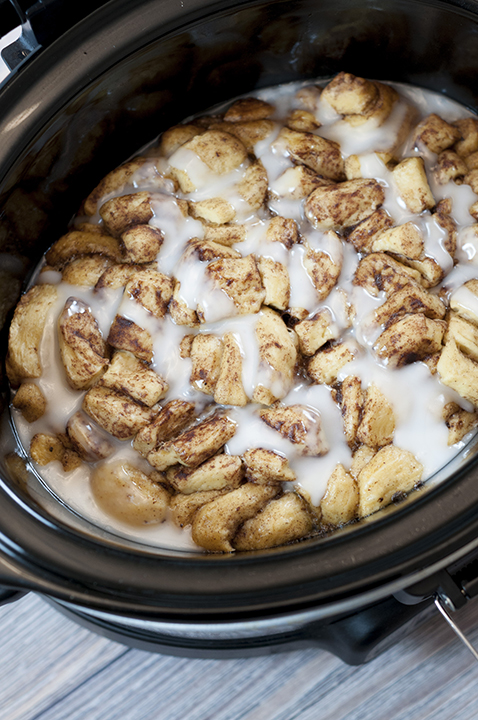 Simple, delicious, Gooey Crock Pot Cinnamon Roll Casserole recipe is sure to be a favorite for breakfast, brunch, the holidays or when you want breakfast for dinner! Your family will adore this!
