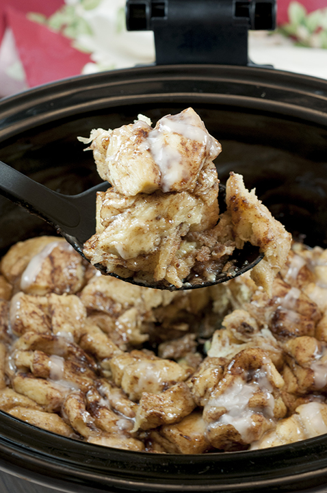 Easy, delicious, Gooey Crock Pot Cinnamon Bun Casserole recipe is sure to be a favorite for breakfast, the holidays or when you want breakfast for dinner! Your family will devour this!