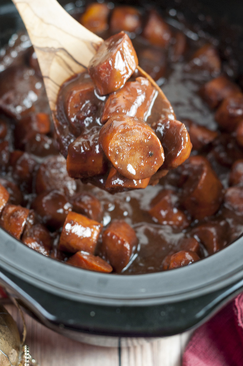 Crock Pot Grape Jelly BBQ Cocktail Sausage appetizer recipe contains buffalo chicken sausage in an easy sweet and savory sauce to serve to guests at your next holiday party! They stay warm in your slow cooker all night!