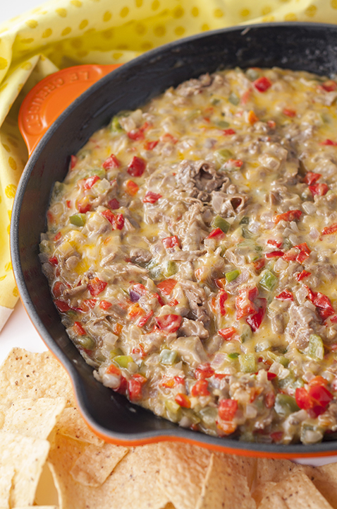 Philly Cheesesteak Dip recipe is made with shaved roast beef, colorful peppers, and loads of ooey gooey cheese. Perfect for game day, holidays or an appetizer to serve at a party!