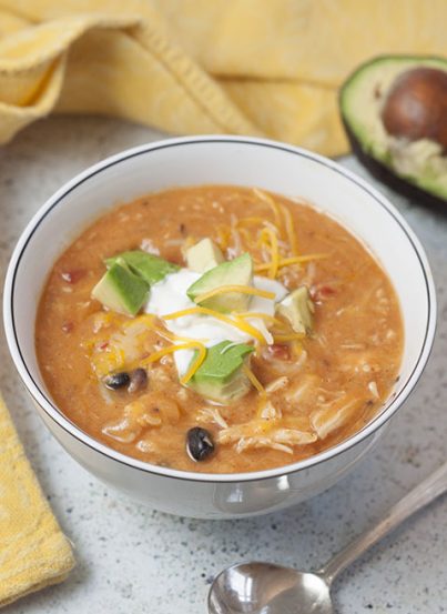 Flavorful and hearty 20 Minute Cheesy Chicken Enchilada Soup recipe is incredibly easy to cook up and full of the BEST flavors. Serve it with tacos and guacamole for Taco Tuesday!