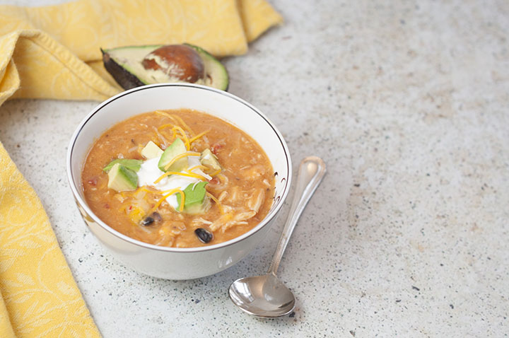 Flavorful and filling 20 Minute Cheesy Chicken Enchilada Soup recipe is incredibly easy to cook up and full of the BEST flavors. Serve it with tacos for Taco Tuesday!