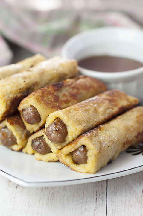 This sweet and savory recipe for Mini French Toast Sausage Roll-Ups served with warm maple syrup for dunking will be the best addition to your Easter or holiday breakfast, brunch, and "brinner"!