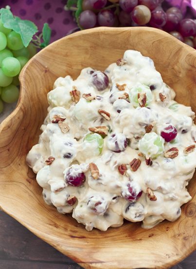 You're just 7 ingredients away from this Creamy Pecan Crunch Grape Salad recipe. It is guaranteed to be a huge hit at office potlucks, BBQ's, holiday dinners and parties!