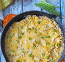 One Pan Sour Cream Chicken Enchilada Skillet recipe made quick and easy in a skillet with corn tortillas pieces, cooked chicken, and a cheesy sauce!
