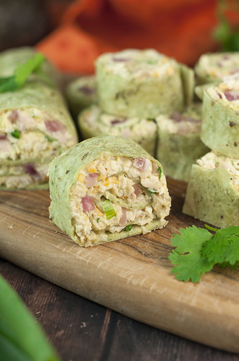 Your party guests will love this recipe for Avocado Chicken Salad Pinwheels. Creamy chicken salad rolled up in tortillas for a healthy game day appetizer or  lunch/dinner for your whole family!