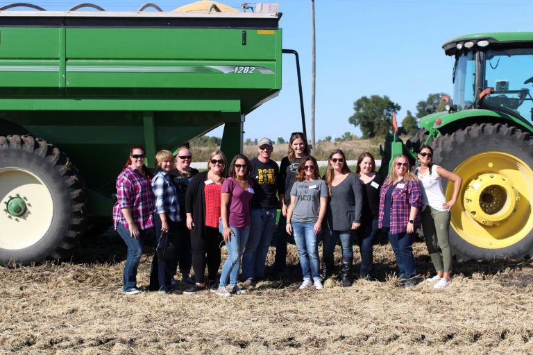 Group photo at Kenney farm in front of the Combine.