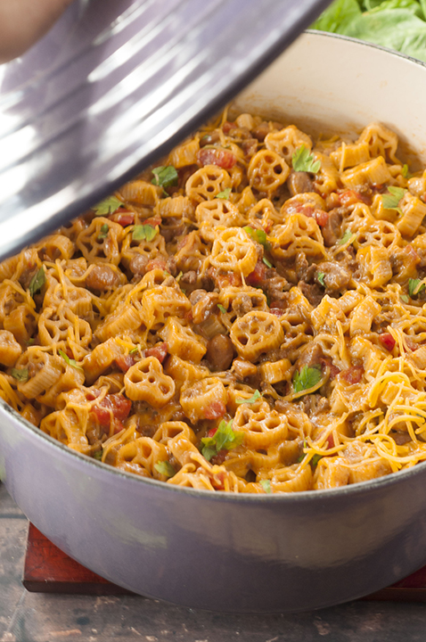 Easy One Pot Chili Mac and Cheese combines two favorite childhood foods: mac 'n cheese and chili. You get the best of both worlds with this hearty dinner with gooey cheese that takes 25 minutes to make!