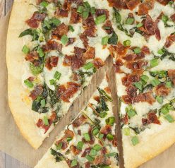 Add some excitement to pizza night with this easy Bacon Alfredo Pizza recipe! Alfredo sauce lovers will go crazy for this and each slice is packed with all your favorite toppings!