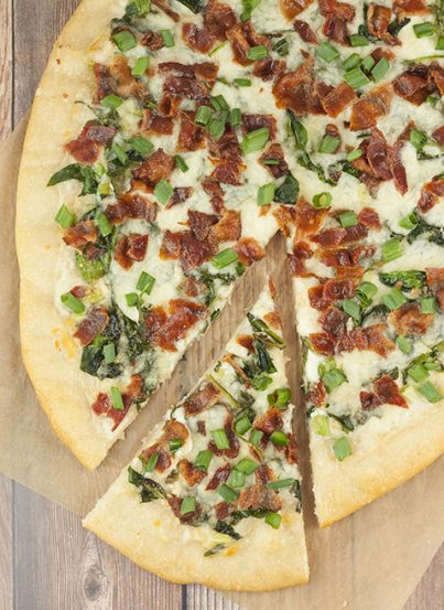 Add some excitement to pizza night with this easy Bacon Alfredo Pizza recipe! Alfredo sauce lovers will go crazy for this and each slice is packed with all your favorite toppings!