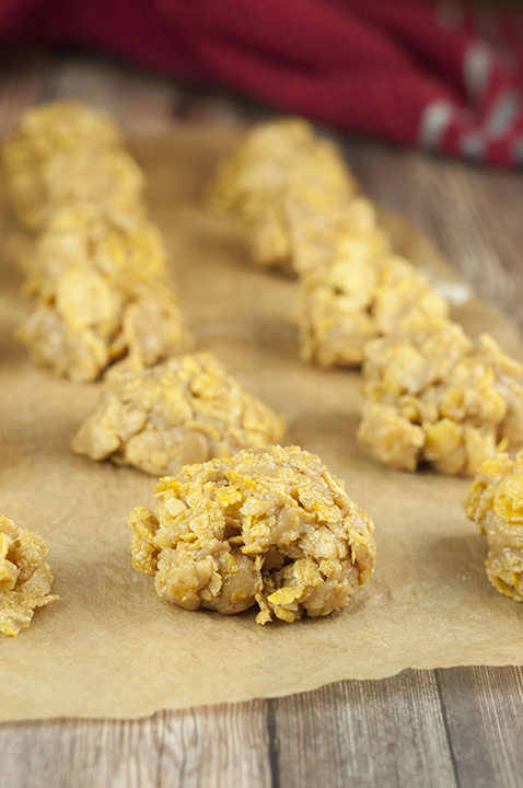 Five simple ingredients make up this No-Bake Grandma's Peanut Butter Corn Flake Clusters recipe that is perfect for Christmas or Thanksgiving dessert! They are so addictive!