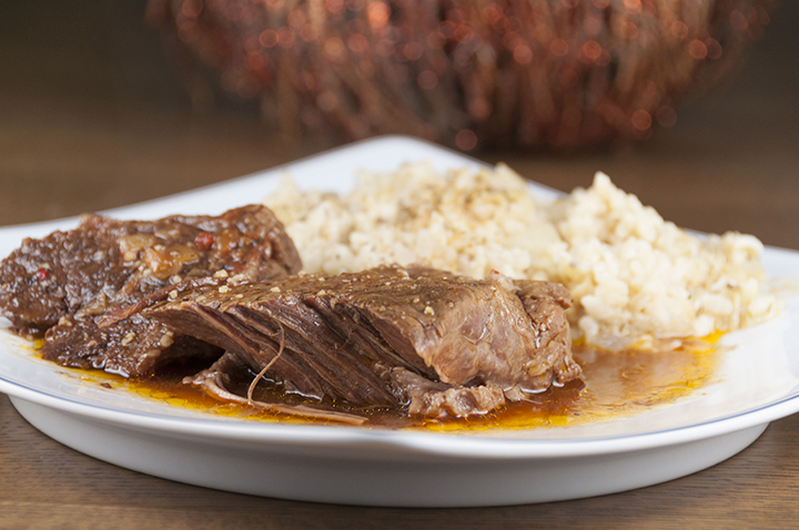 Tender, fall-apart, juicy Slow Cooker Italian Pot Roast recipe is packed with flavor and an easy weeknight mealr. It's fancy enough to serve to dinner guests for a a party or Christmas dinner and the crock pot does all the cooking for you!