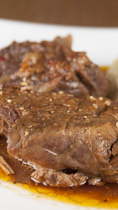 Tender, fall-apart, juicy Slow Cooker Italian Pot Roast recipe is packed full of flavor and an easy weeknight dinner. It's fancy enough to serve to dinner guests for a Christmas dinner and the crock pot does all the work!