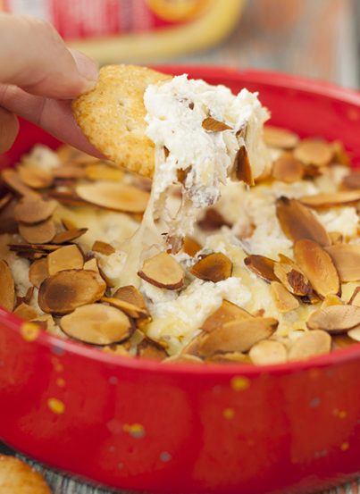 Toasted Almond Cheese Dip recipe is a quick and easy dip recipe for the holidays or game day appetizer idea! Who doesn't love a hot, creamy cheese dip topped with crunchy sliced almonds?