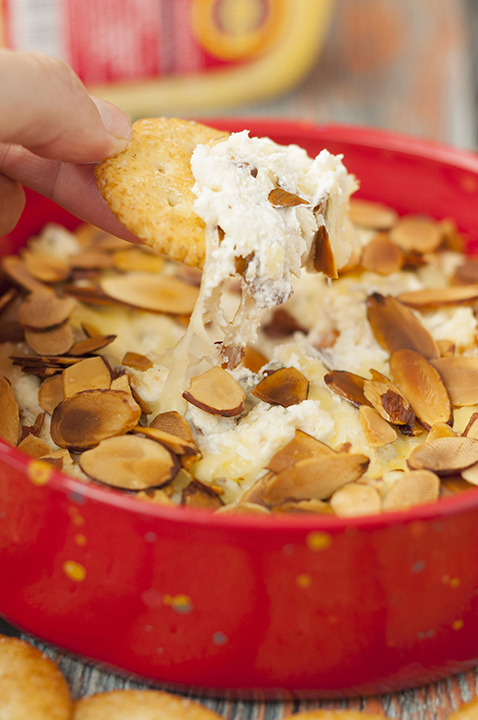 Toasted Almond Cheese Dip recipe is a quick and easy dip recipe for the holidays or game day appetizer idea! Who doesn't love a hot, creamy cheese dip topped with crunchy sliced almonds?