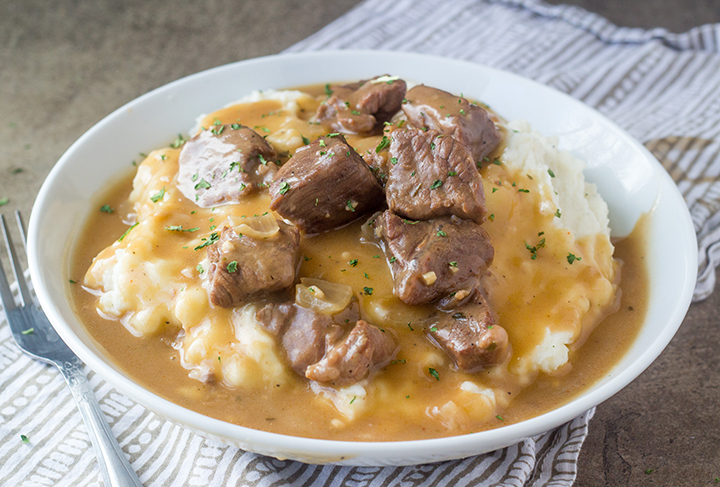 Crock Pot or Slow Cooker Beef Tips and Gravy is perfect to serve to dinner guests but simple enough for a weeknight supper recipe! Serve it over noodles, potatoes or rice!