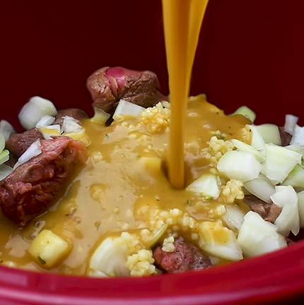 Adding all of the ingredients to the crock pot for my Slow Cooker Beef Tips and Gravy recipe.