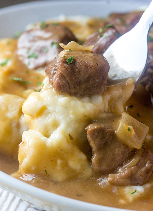 Slow Cooker Beef Tips and Gravy is perfect to serve to dinner guests but simple enough for a weeknight dinner or appetizer recipe! Serve it over noodles, potatoes or rice and the crock pot does all the work!