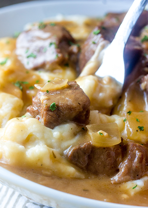 Slow Cooker Beef Tips and Gravy is perfect to serve to dinner guests but simple enough for a weeknight dinner recipe! Serve it over noodles, potatoes or rice!