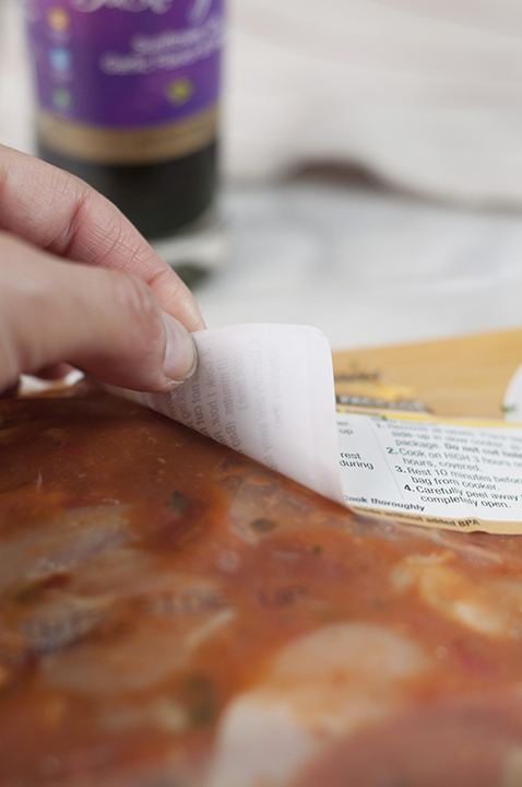 Peeling off the label of the plastic package for the Chicken Cacciatore.