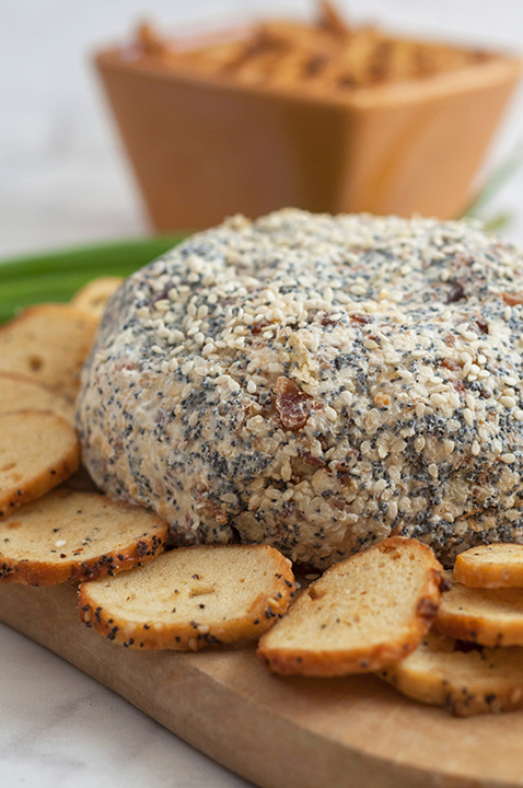 Get the Super Bowl, Christmas, or holiday party started with this Everything Bagel Cheese Ball recipe: all the flavors of your favorite everything bagel turned into a delicious cheese ball appetizer! Serve it with bagel chips and watch it disappear.