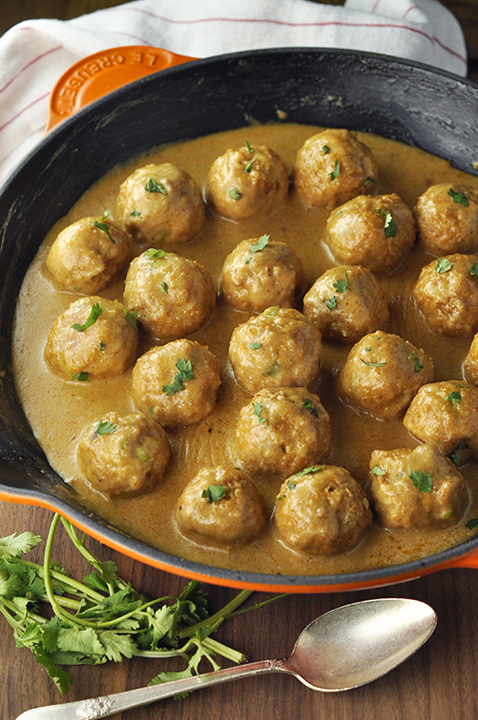 Easy Skinny Thai Peanut Chicken Meatballs dinner recipe served over rice with an abundance of sweet, and a bit spicy, coconut peanut butter sauce that you will want to just eat with a spoon! This is a dinner idea I make regularly and you'll see why.