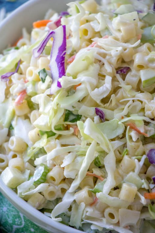 Easy Macaroni Coleslaw Salad is packed with colorful vegetables and pasta and a beautiful combination of your two favorite summer side dishes: coleslaw and macaroni salad! This is a great, easy recipe to take to a potluck or BBQ.