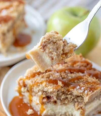 Easy Salted Caramel Apple Cheesecake Bars is the perfect fall and autumn baking recipe with a shortbread crust, cheesecake filling, and an irresistible streusel topping. The salted caramel drizzle makes these the perfect fall dessert for Thanksgiving dessert or Christmas dessert!