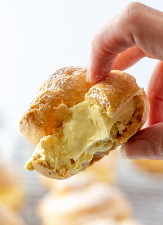 My famous easy, authentic Homemade Cream Puffs recipe: light and airy cream puffs filled with vanilla pudding cream are always a hit with family and anyone I've served them to. If you want an impressive, pretty dessert for Christmas, Easter brunch, or any holiday, this one is it!
