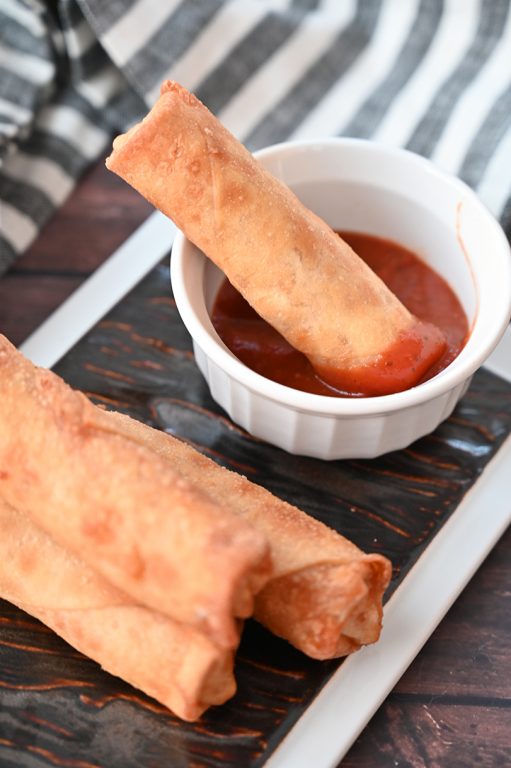 Crowd-Pleasing Baked Pepperoni Pizza Rolls recipe using egg roll wrappers is my version of the store-bought pizza rolls or pizza logs you find at diners or fast food places. These rolls are baked, not fried, so are a healthier appetizer idea!