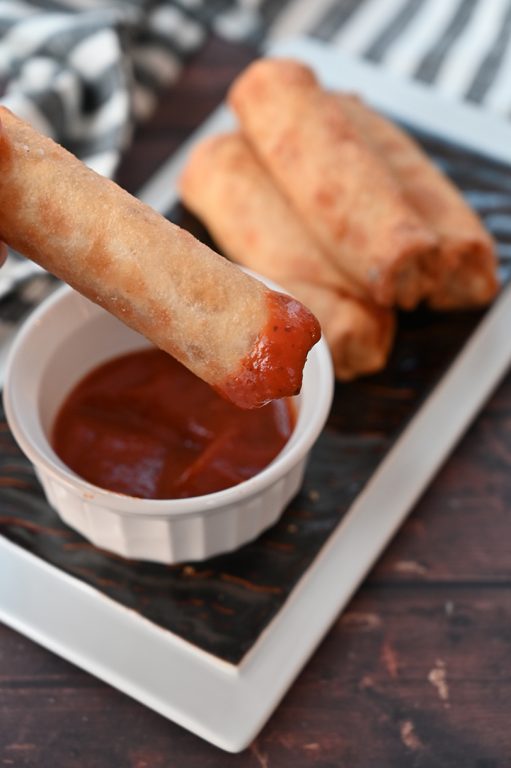Crowd-Pleasing Baked Pepperoni Pizza Rolls recipe using egg roll wrappers is my version of the store-bought pizza rolls or pizza logs you find at the diners. These rolls are baked, not fried!