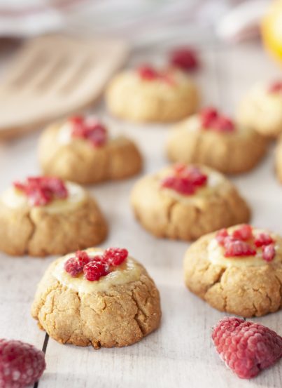 New York Raspberry Cheesecake Cookies recipe perfect for Valentine's Day or any holiday dessert! Your favorite dessert made into perfectly balanced sweet and tart cookies with fresh raspberries on top.