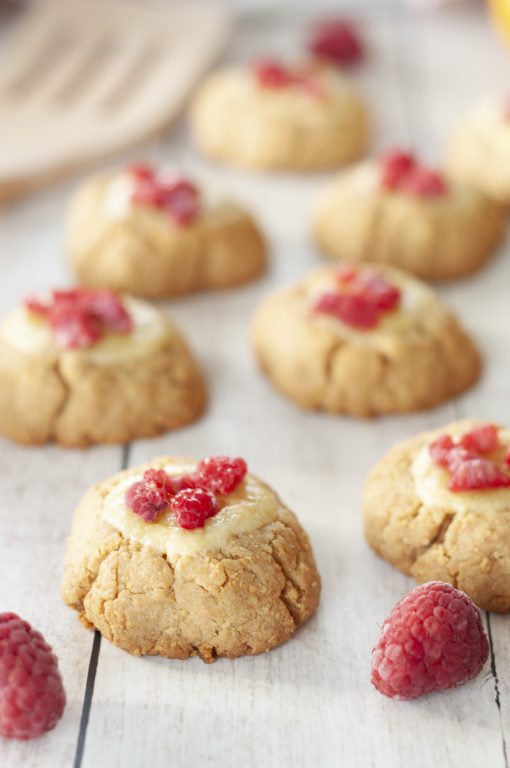 Easy New York Raspberry Cheesecake Cookies recipe perfect for Valentine's Day, Christmas cookie, or any holiday dessert! Your favorite dessert made into perfectly balanced sweet and tart cookies with fresh raspberries or other fruit on top.