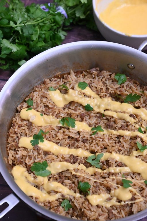 Skillet Taco Rice with Queso filled with tex-mex flavor is an easy, cheesy Mexican dinner recipe idea! You will want to eat this every day and it's low carb!