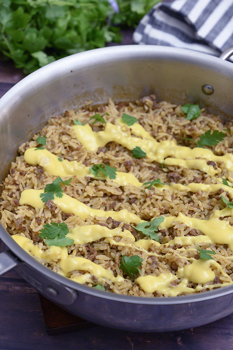 Skillet Taco Rice with Queso filled with tex-mex flavor is an easy, cheesy Mexican dinner recipe idea! You will want to eat this every day!