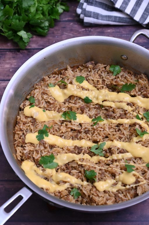 Skillet Taco Rice with Queso filled with tex-mex flavor is an easy, cheesy Mexican dinner recipe idea with simple ingredients! You will want to eat this every day and it is low carb!