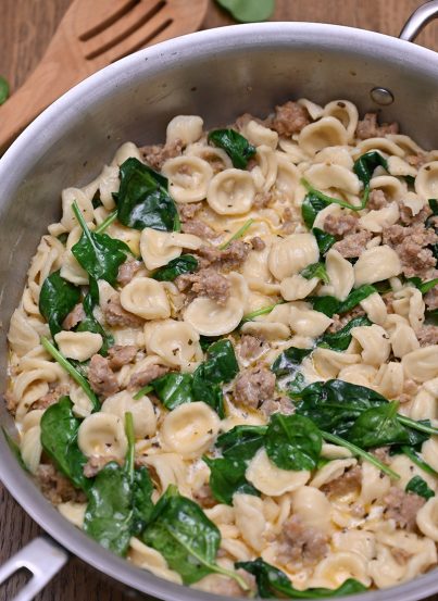 Creamy Spinach Sausage Pasta is an easy pasta dish recipe (30 minutes start to finish): pasta and seasoned Italian sausage tossed in a simple, light cream sauce making it the perfect weeknight meal!