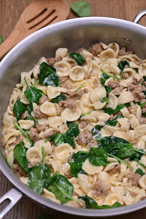 Creamy Spinach Sausage Pasta is an easy pasta dish recipe (30 minutes start to finish): pasta and seasoned Italian sausage tossed in a simple, light cream sauce making it the perfect weeknight meal!