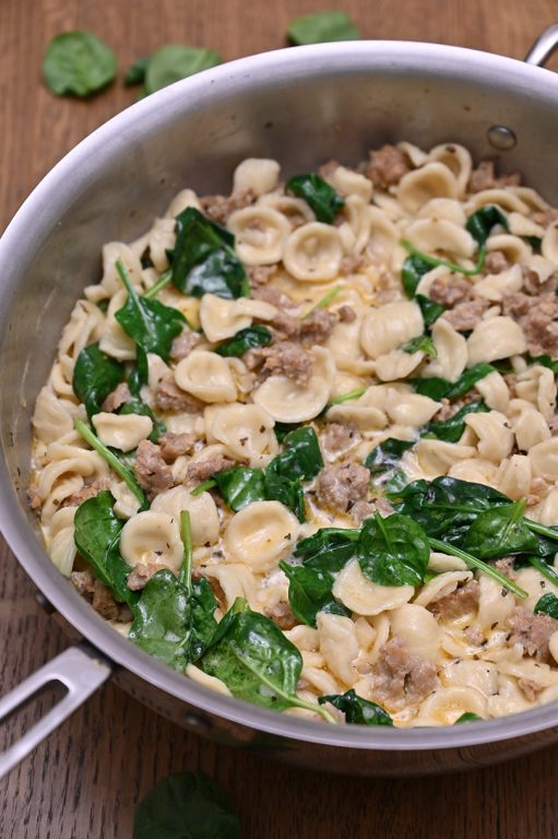 Creamy Spinach Sausage Pasta is an easy pasta dish recipe made in 30 minutes. Pasta and seasoned Italian sausage tossed in a simple, light cream sauce making it the perfect family weeknight meal!