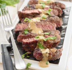Grilled Ribeye Steak with Onion Blue Cheese Sauce recipe is absolutely divine and the perfect choice for a summer cookout! No need to go to your local steakhouse when you can make it easily right at home!