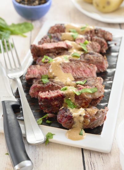 Grilled Ribeye Steak with Onion Blue Cheese Sauce recipe is absolutely divine and the perfect choice for a summer cookout! No need to go to your local steakhouse when you can make it easily right at home!