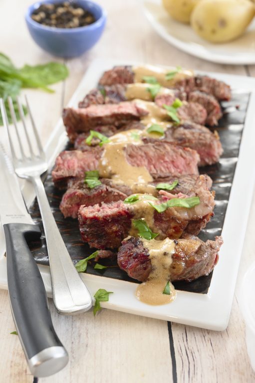 Grilled Ribeye Steak with Onion Blue Cheese Sauce recipe is absolutely divine and the perfect choice for a summer cookout! No need to go to your local steakhouse when you can make it easily right at home!