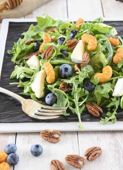 An easy, gluten-free salad recipe with fruit: Blueberry-Brie Pecan Salad with Protein Puff Croutons. The protein puffs and candied pecans add so much crunch and flavor!