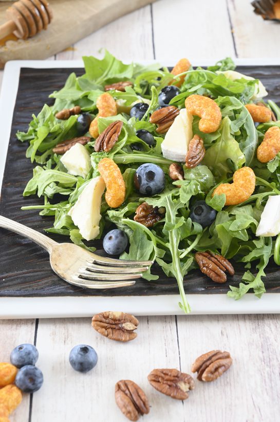 An easy, gluten-free salad recipe with fruit: Blueberry-Brie Pecan Salad with Protein Puff Croutons. The protein puffs and candied pecans add so much crunch and flavor!
