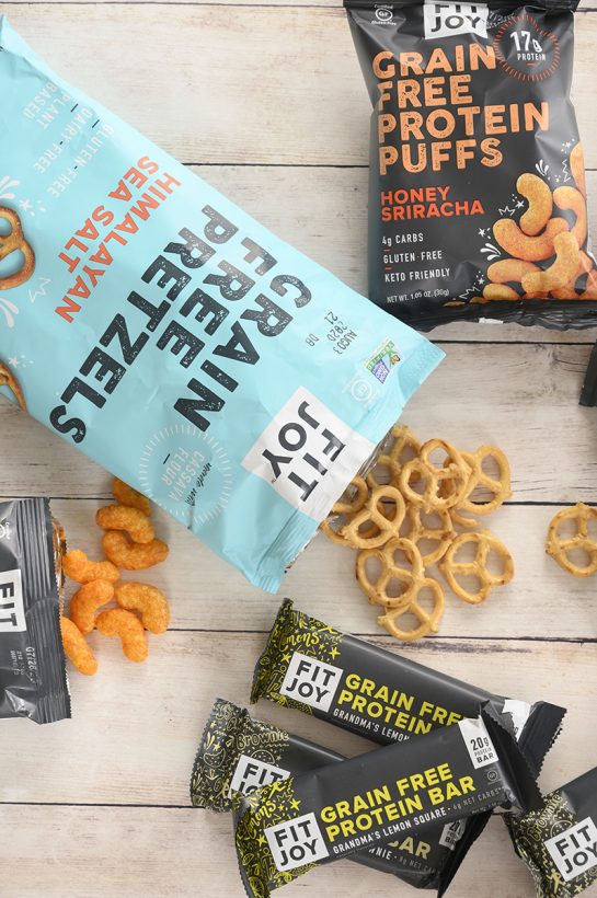 FitJoy grain free pretzels, protein puffs, and protein bars.