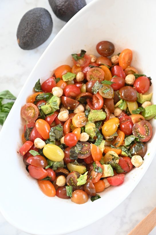 Light, refreshing, healthy Caprese Avocado Salad recipe packed with fresh mozzarella cheese is a quick and easy meal in a salad! This is great for any picnic, holiday, or BBQ!