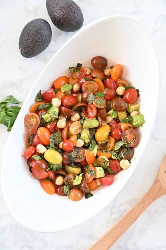 Light, refreshing, healthy Caprese Avocado Salad recipe packed with fresh mozzarella cheese is a quick and easy side dish idea in a salad! This is great for any picnic, holiday, or BBQ!