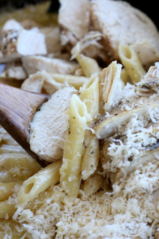 Close up view of crock pot chicken alfredo that was cooked in a slow cooker.